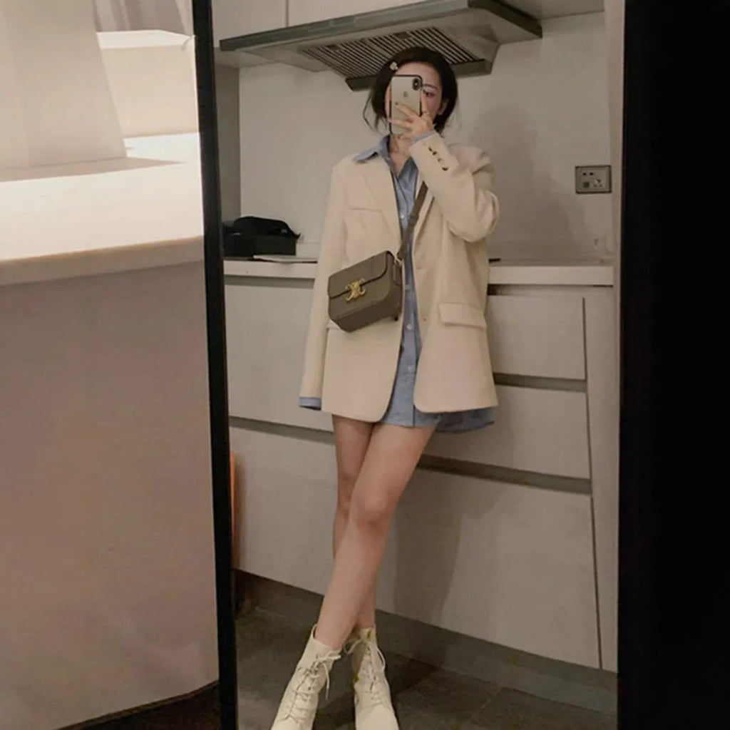 Men's beige Korean-style casual suit jacket with long sleeves and a chest pocket on a hanger.