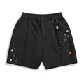 Men's black loose-fit shorts with semi-elastic waistband and colour button closure