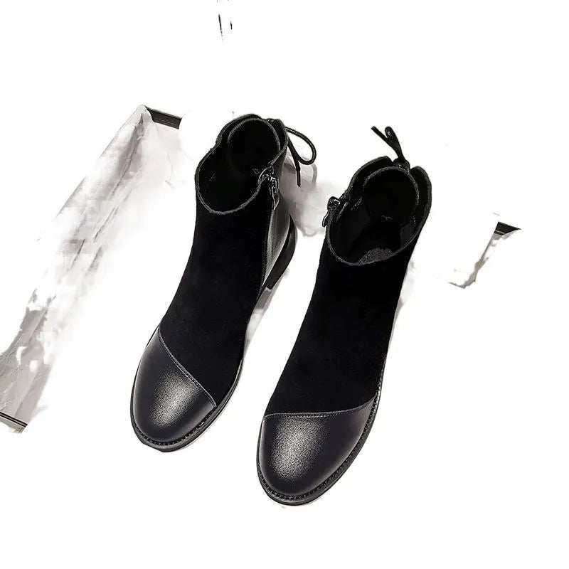 Women's black knee-high Martin boots with side zipper, round toe, and short stout heel.