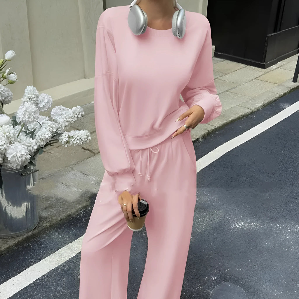 Women's apricot colour polyester trousers two-piece set with long sleeves laid flat.