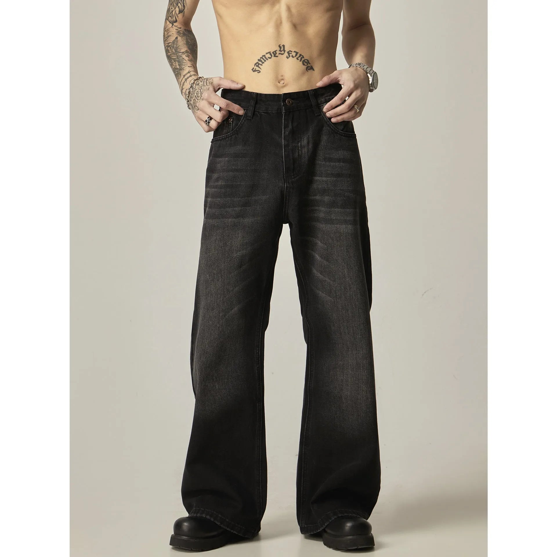 Black loose fit straight leg retro jeans on a hanger, showing zipper fly and relaxed silhouette.