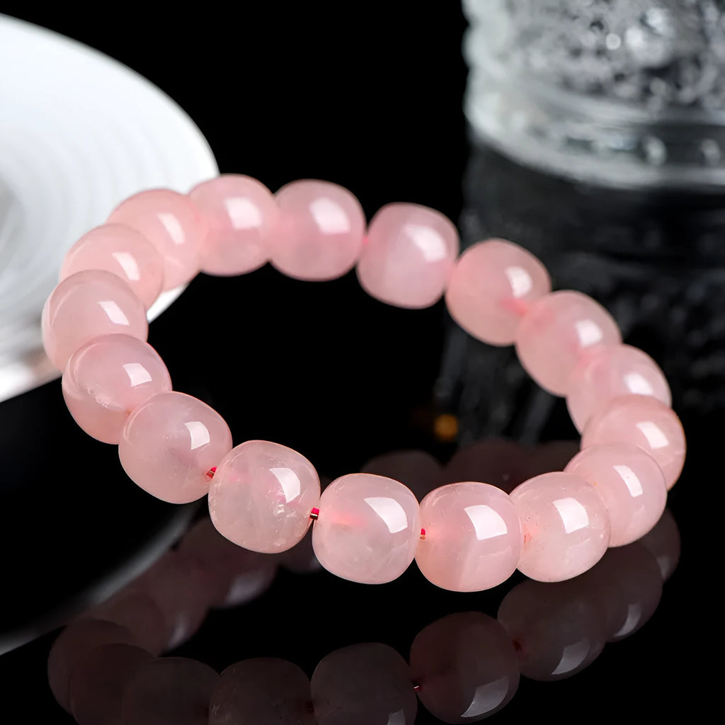 Pink natural crystal barrel bead bracelet with geometric shapes measuring 8-10mm