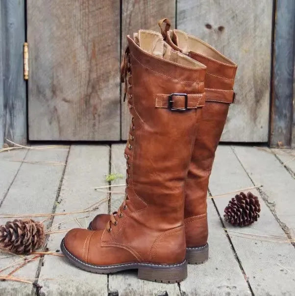 Women's black high leg boots with a chunky low heel and round toe on a solid background.
