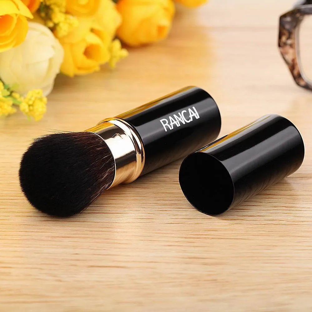 Single mini retractable makeup brush with aluminium tube and fibre wool bristles, 9cm long, available in black or red