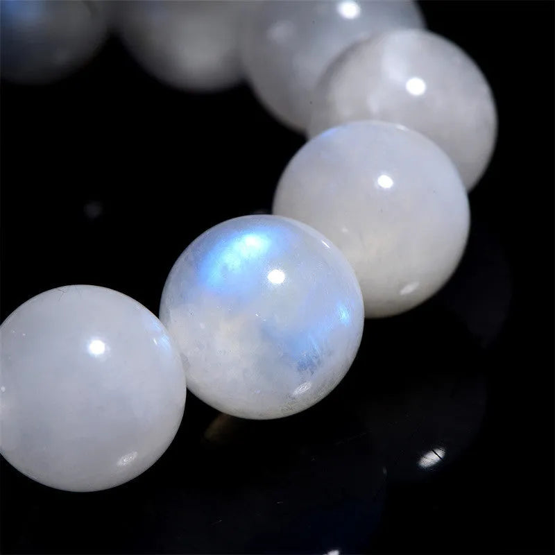 Natural blue moonlight round bead moonstone bracelet showing polished geometric beads on wrist