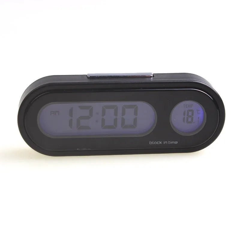 Black car dashboard clock thermometer with luminous LED display showing time and temperature