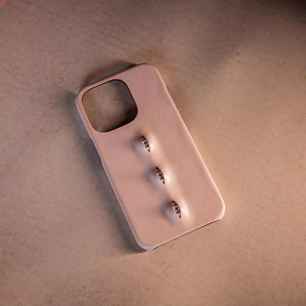 Handmade waxed cowhide leather eye phone case in pink with three-eye vertical design