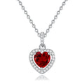 Close-up of a sterling silver heart pendant necklace with an inlaid amethyst gemstone on a cross chain.