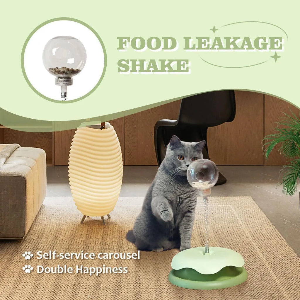 Blue and green interactive cat treat dispenser toy with a track ball on a wooden floor.