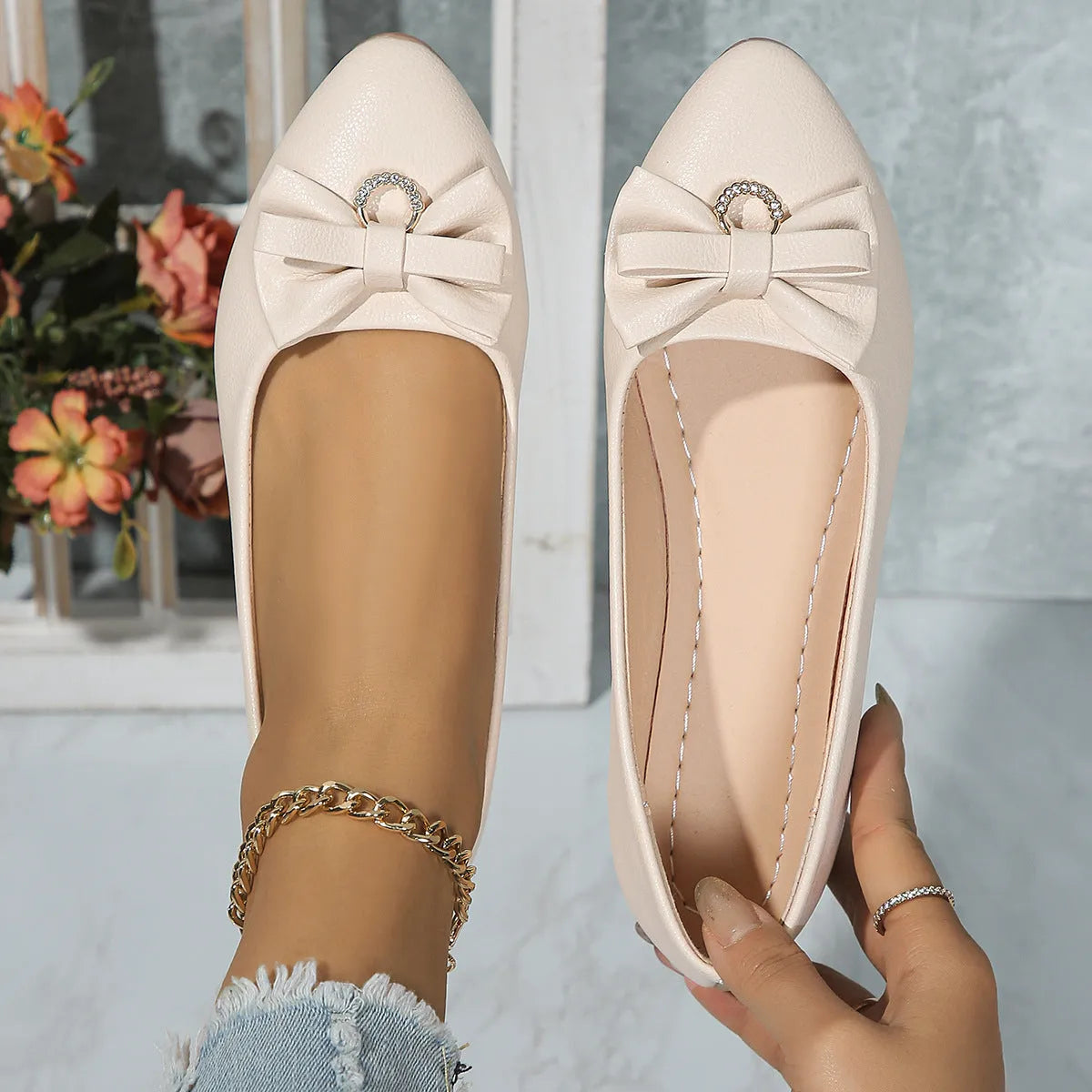Women's beige casual flat shoes with a bowknot detail and slip-on shallow mouth design.