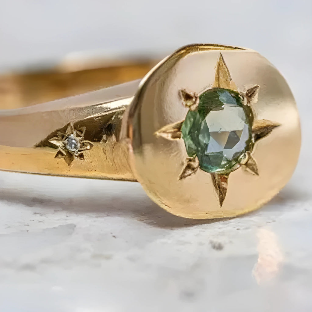 Golden star-shaped ring with oval zircon stone and adjustable band.