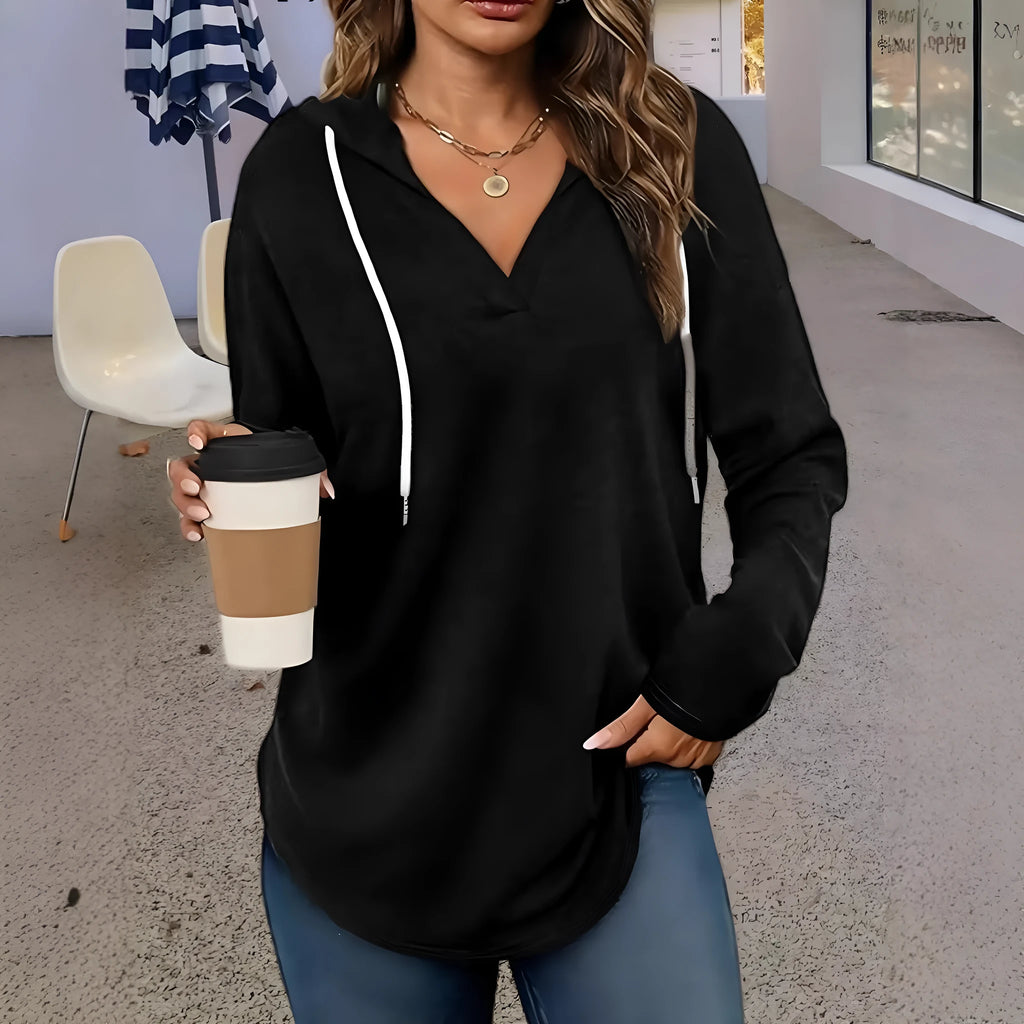 Women's red V-neck sweatshirt with hood and long sleeves showing loose fit design