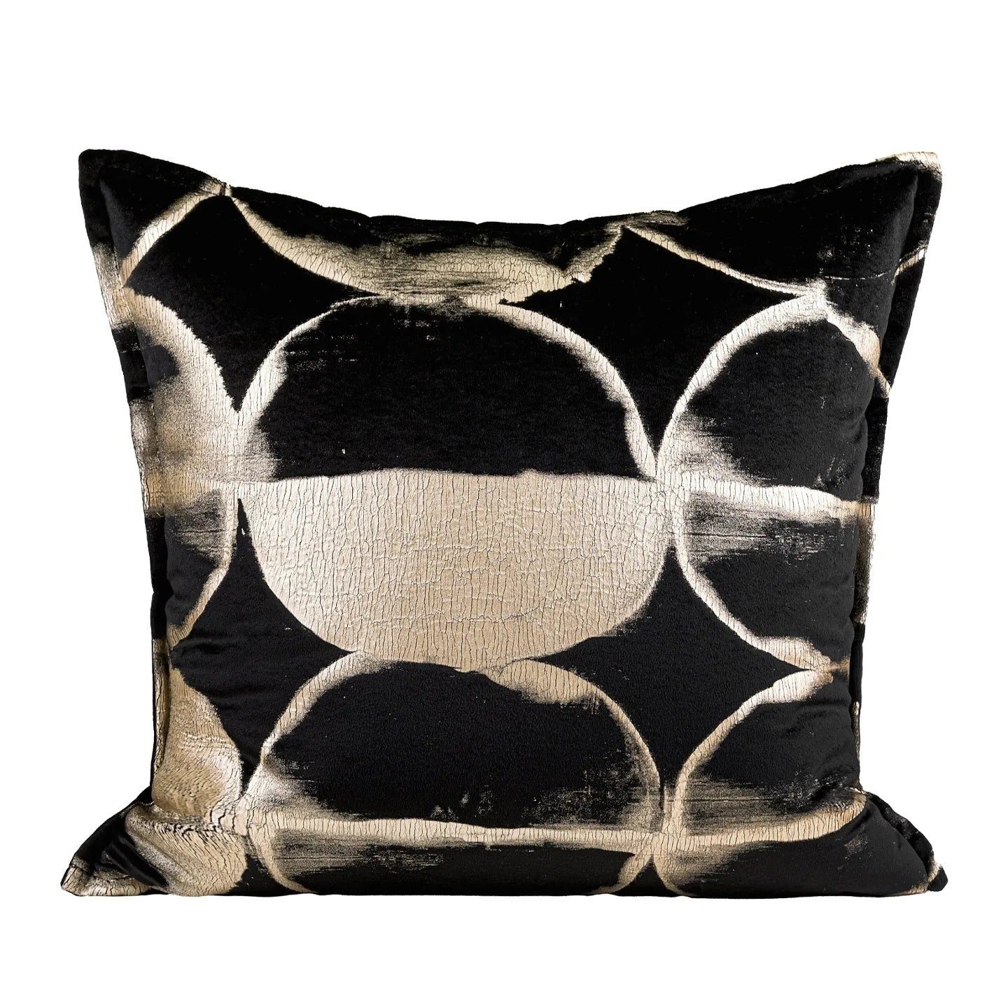 Black and gold abstract patterned flannel decorative cushion on a grey sofa.