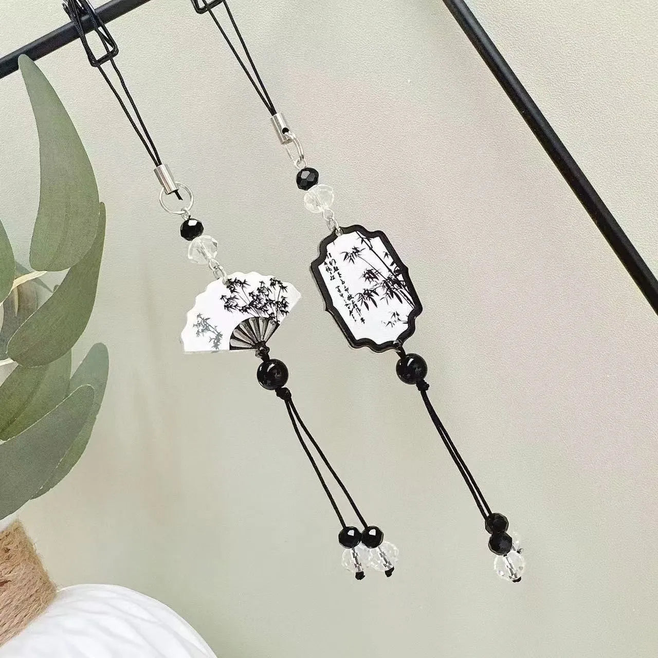 Guofeng Chinese style bead pendant keychain with detailed plant and flower pattern in a glossy finish.