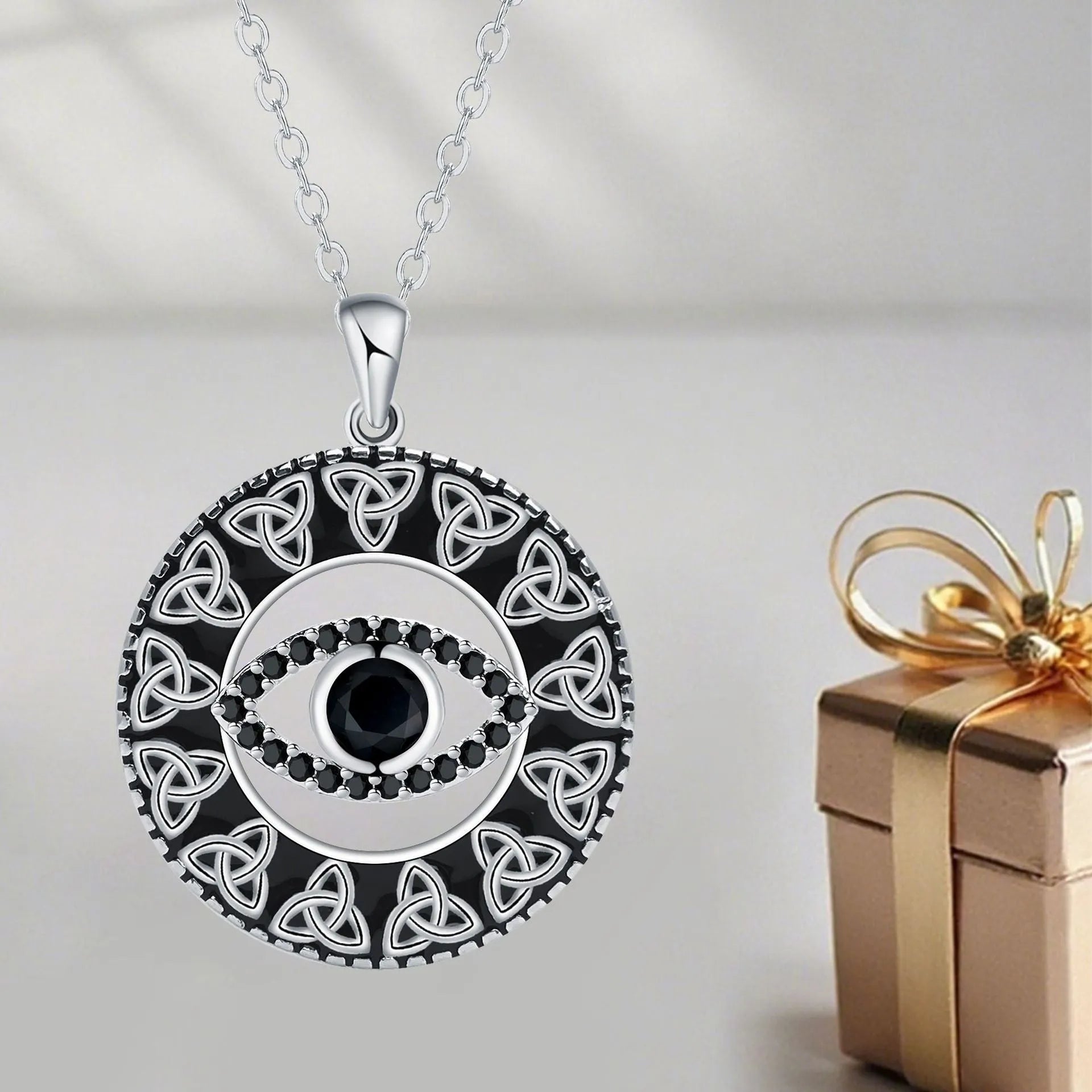 Close-up of a copper Devil's Eye pendant necklace on a cross chain for women.