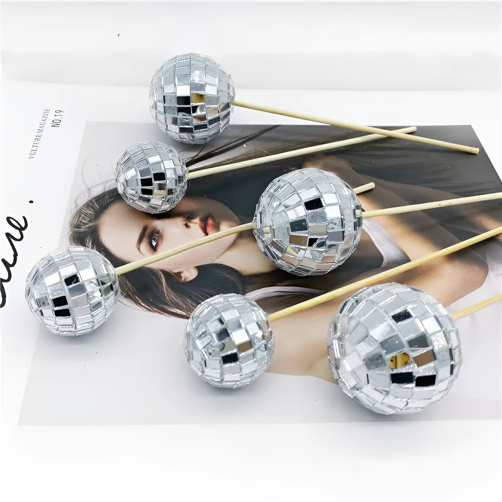 Glass mirror ball cake decoration on a wooden stick, available in four different sizes.