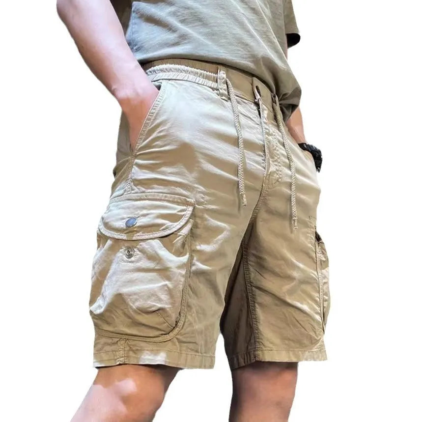 A pair of loose straight leg casual overalls with multiple front pockets, shown in a khaki colour.