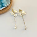 Women's shell pearl tassel earrings with acrylic construction and choice of ear clip types