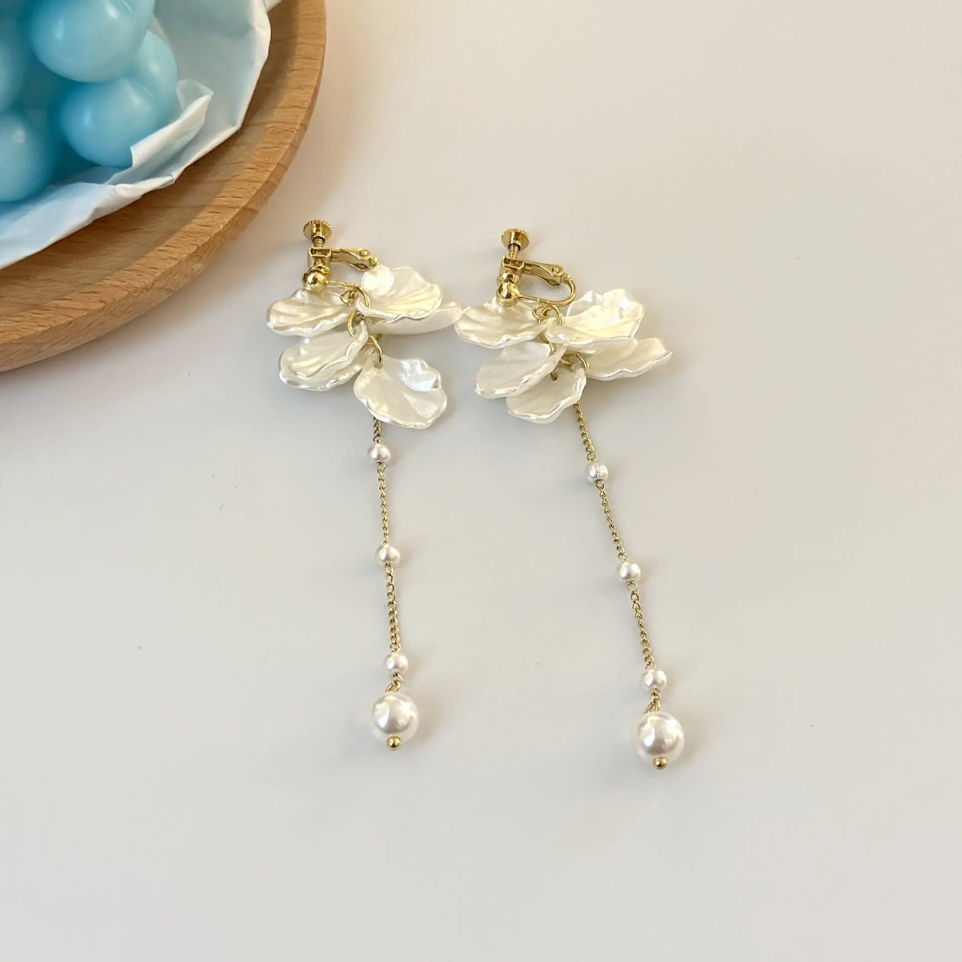 Women's shell pearl tassel earrings with acrylic construction and choice of ear clip types