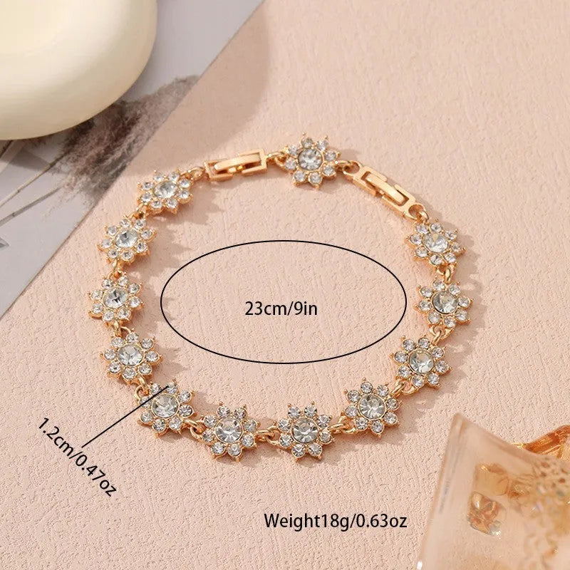Adjustable zinc alloy bracelet with electroplated flower-shaped links in gold and silver colour options with gemstone accents.