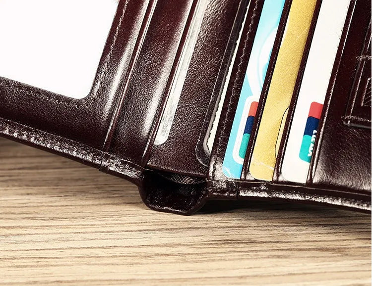 Men's leather wallet open to show internal card slots, cash section, coin pocket, and document holder.