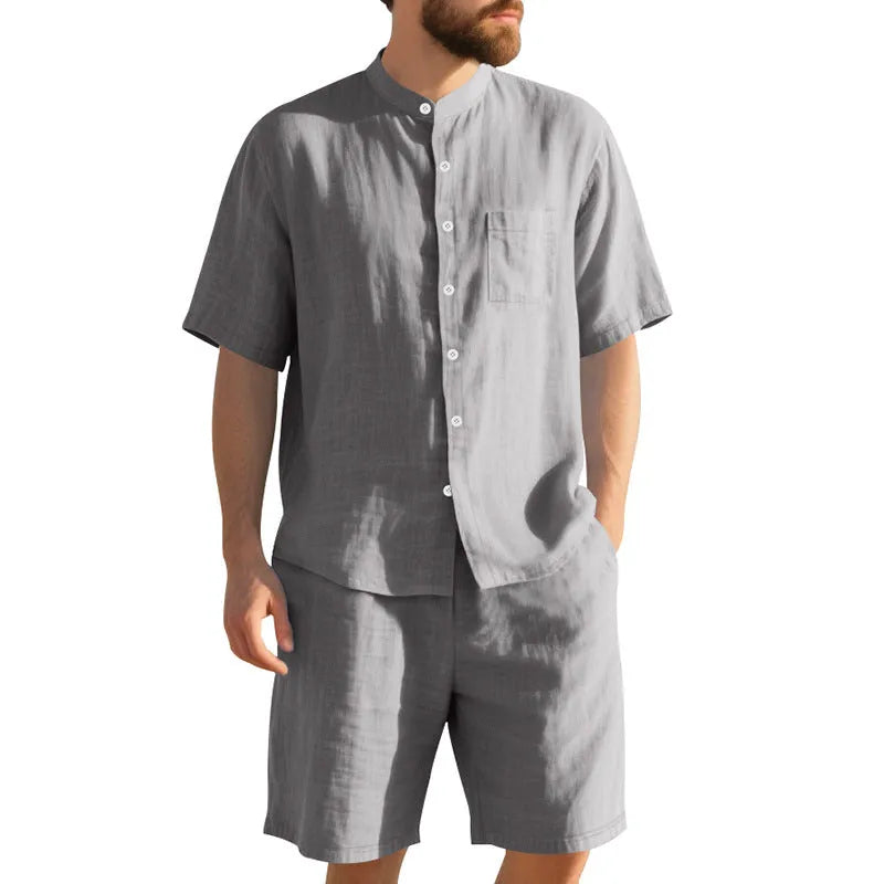 Men's light blue linen blend two-piece suit with short sleeve shirt jacket and shorts on a hanger.