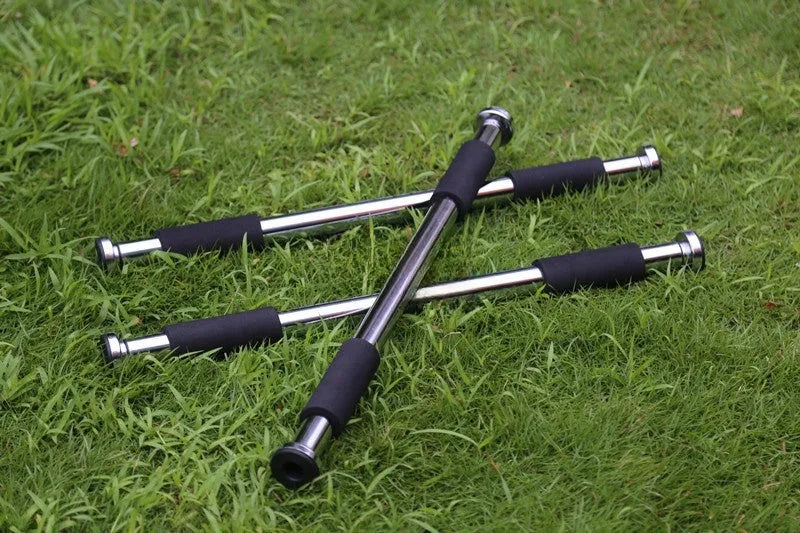 Adjustable steel pull-up bar extended across doorway showing parallel grip positions