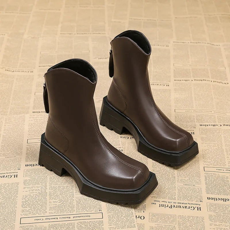 Black platform Martin ankle boots for women with a square toe and back zipper on a white background.