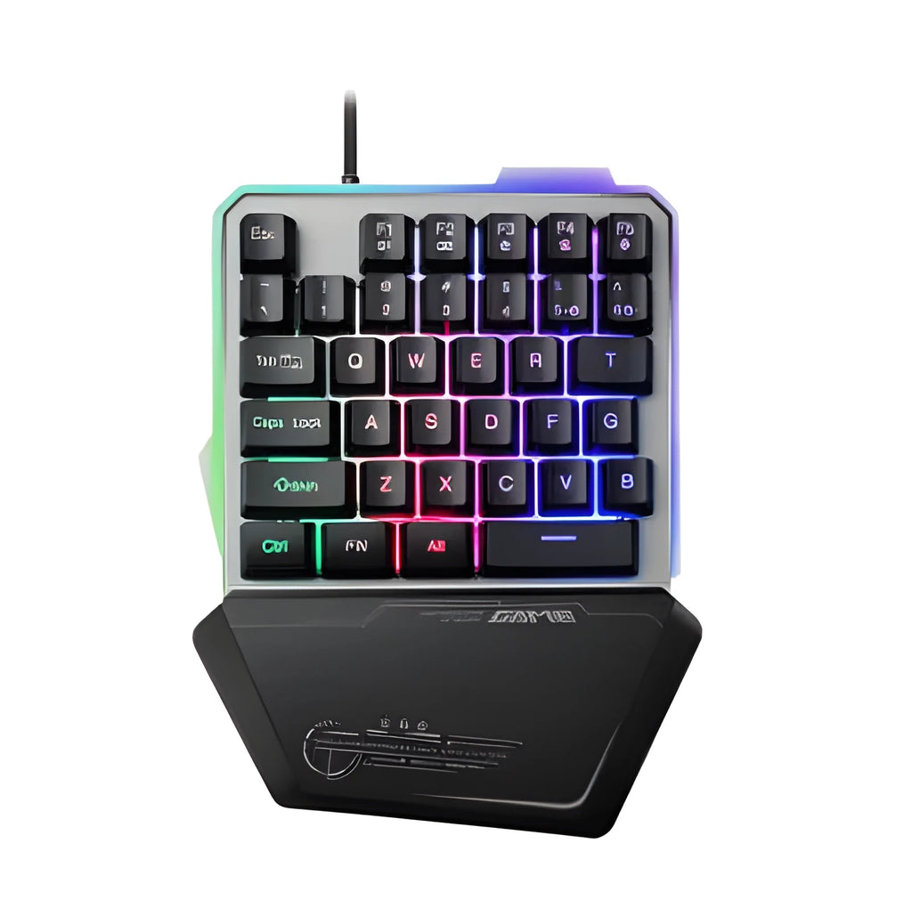 Black one-handed robotic gaming keyboard with RGB backlit keys on a desk.