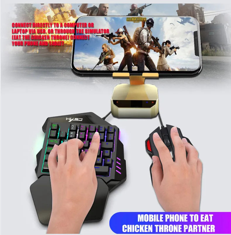 V100 one-handed black mini keyboard and mouse set on a desk