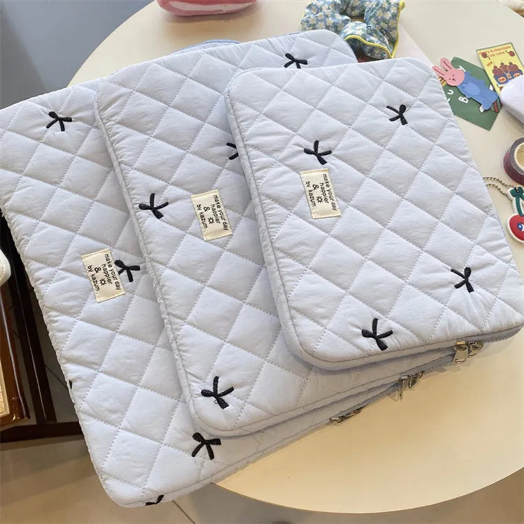 Cute rhombus embroidered bow laptop sleeve in light blue colour, zipper closure.