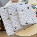 Cute rhombus embroidered bow laptop sleeve in light blue colour, zipper closure.