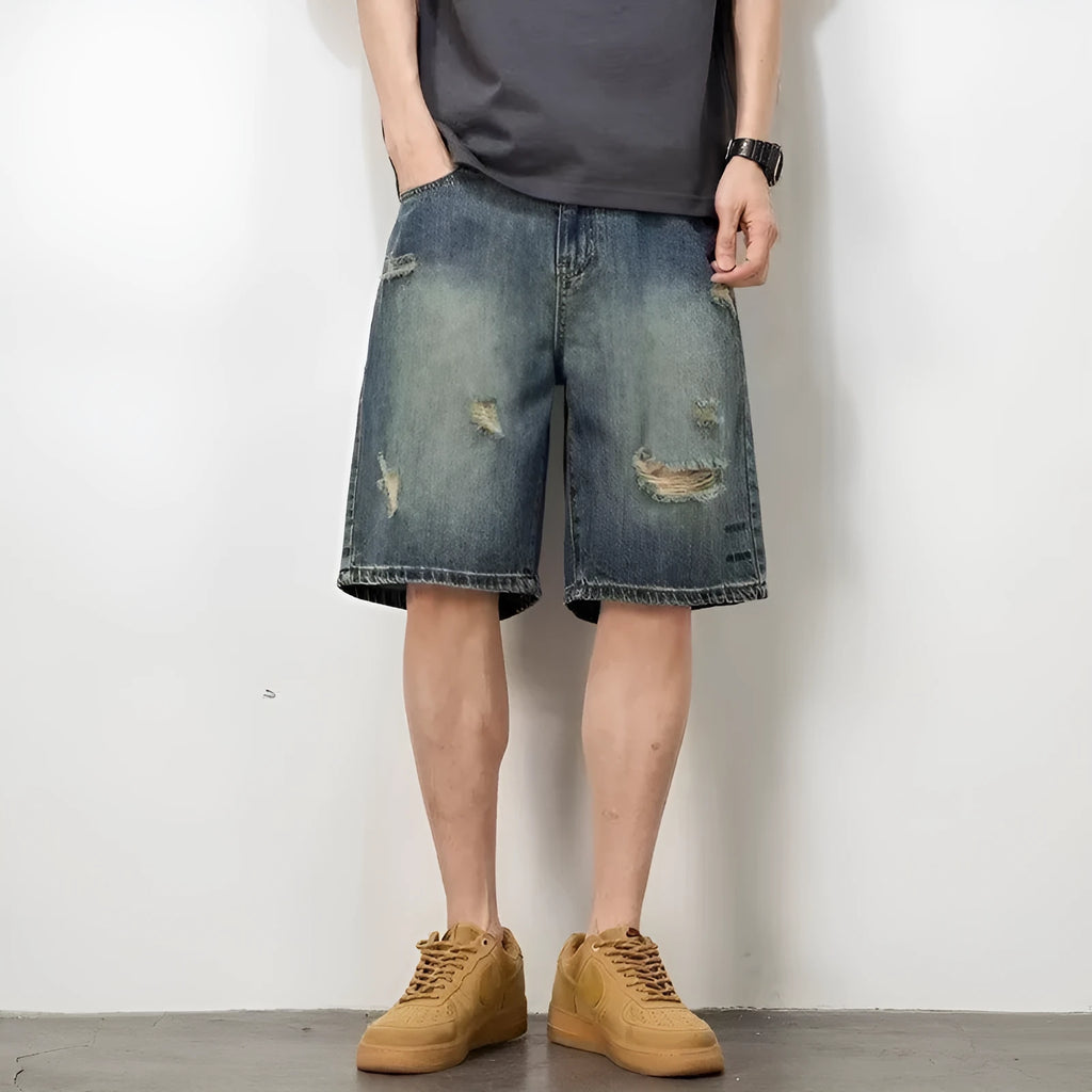 Men's blue denim shorts with retro loose hole distressing and a straight-leg cut.