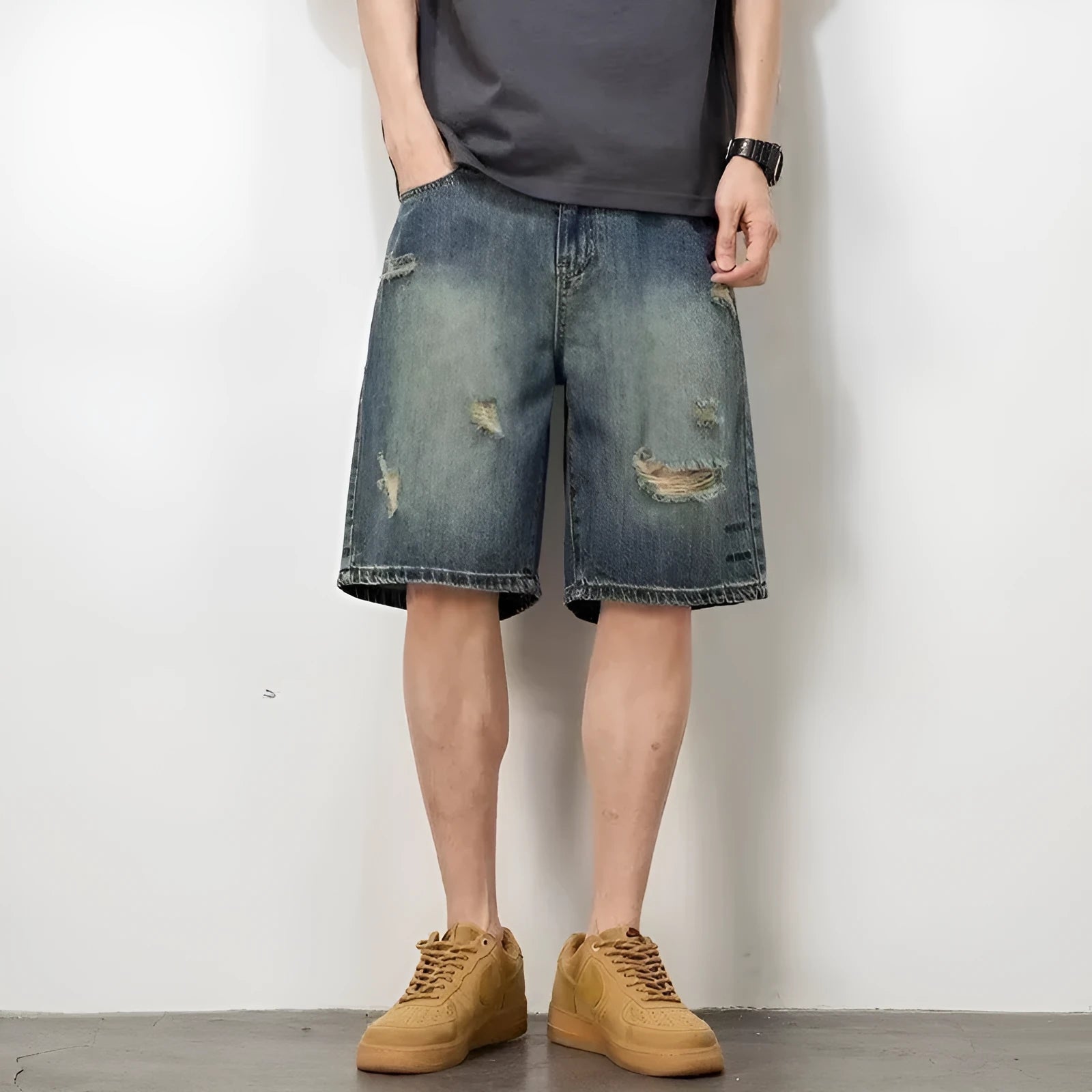 Men's blue denim shorts with retro loose hole distressing and a straight-leg cut.