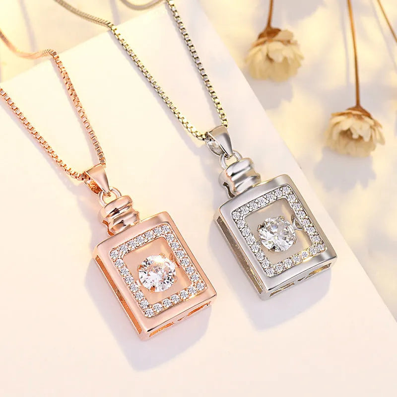 Close-up of a women's silver heart necklace pendant featuring a crown and bow design on a chain.