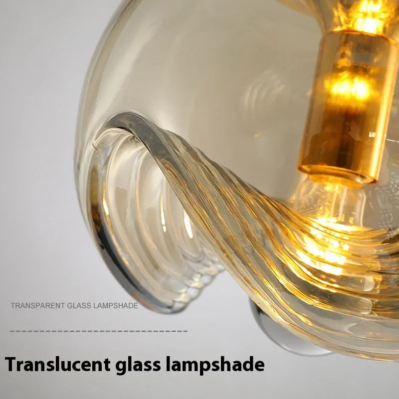 Modern minimalist glass chandelier with 25cm diameter, shown in transparent, amber, or smoky gray colour options.