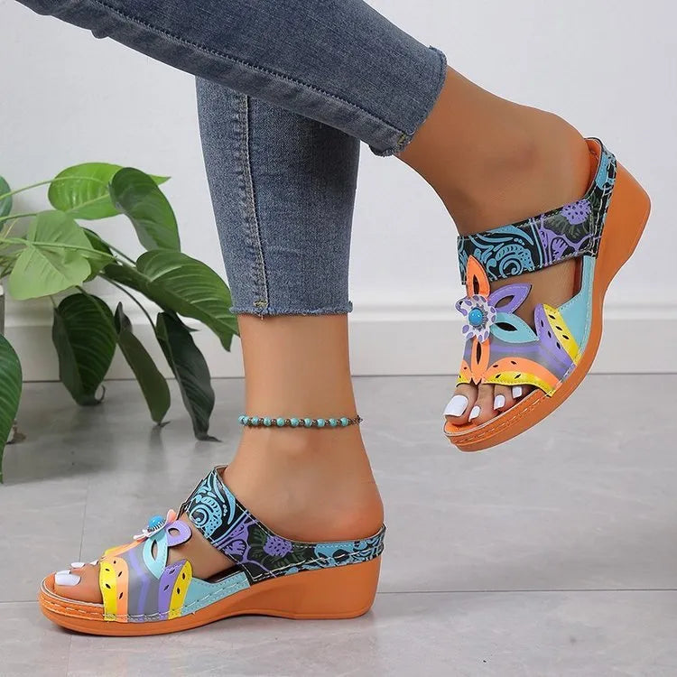 Colourful ethnic print cowhide leather slippers with round toe and rubber sole.