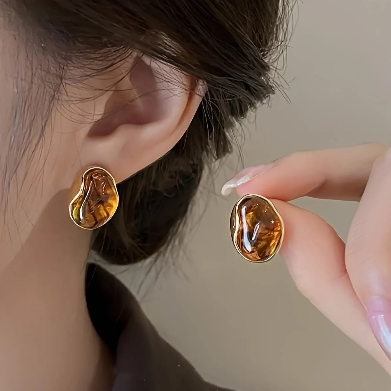 Three pairs of handmade geometric holiday earrings with tassels: irregular, water drop, and round designs.