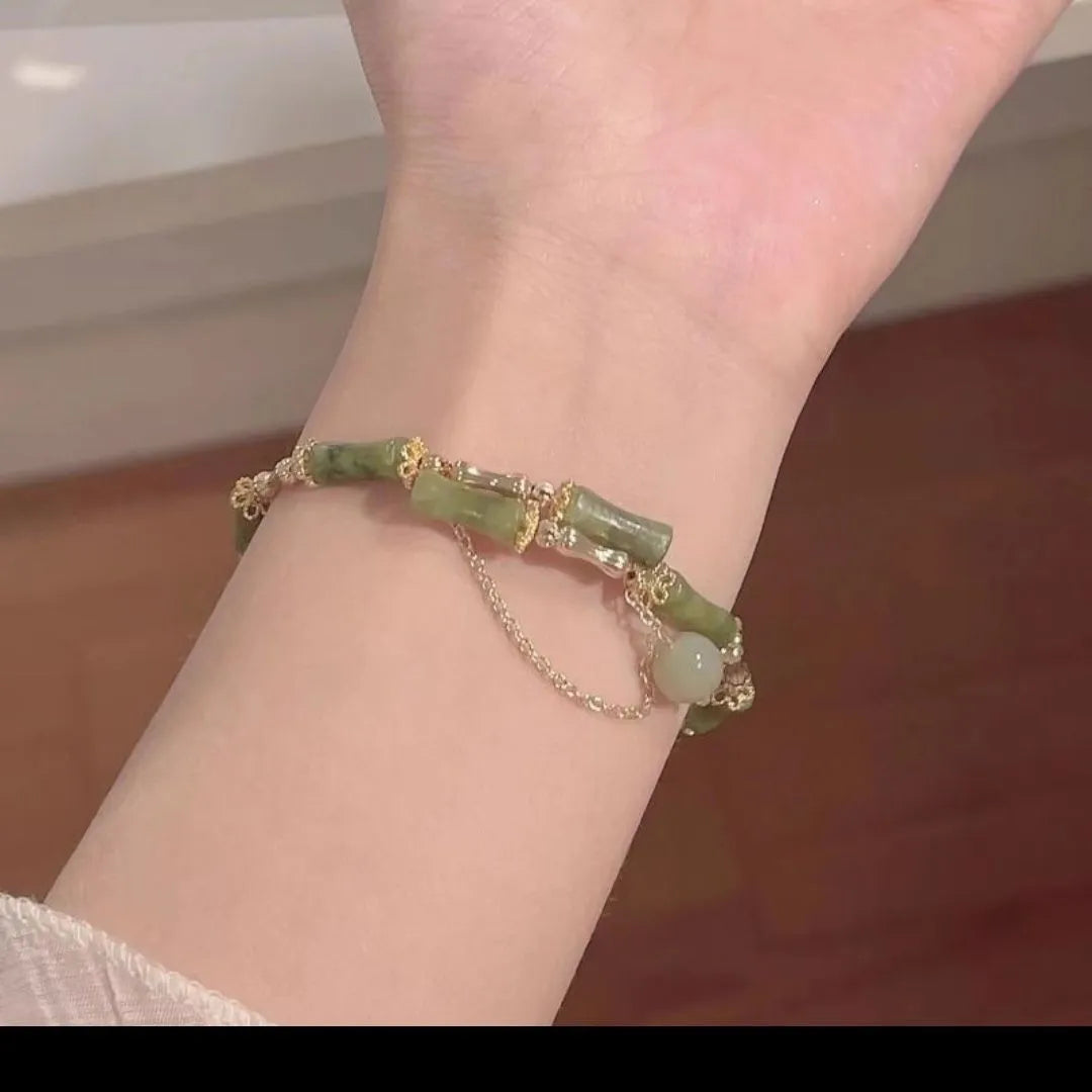 Women's plum wine coloured bamboo joint bracelet with adjustable beaded design