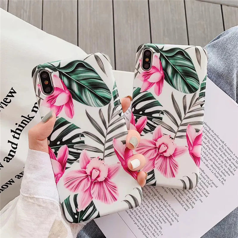 Pink floral patterned TPU back cover case for iPhone on a table.