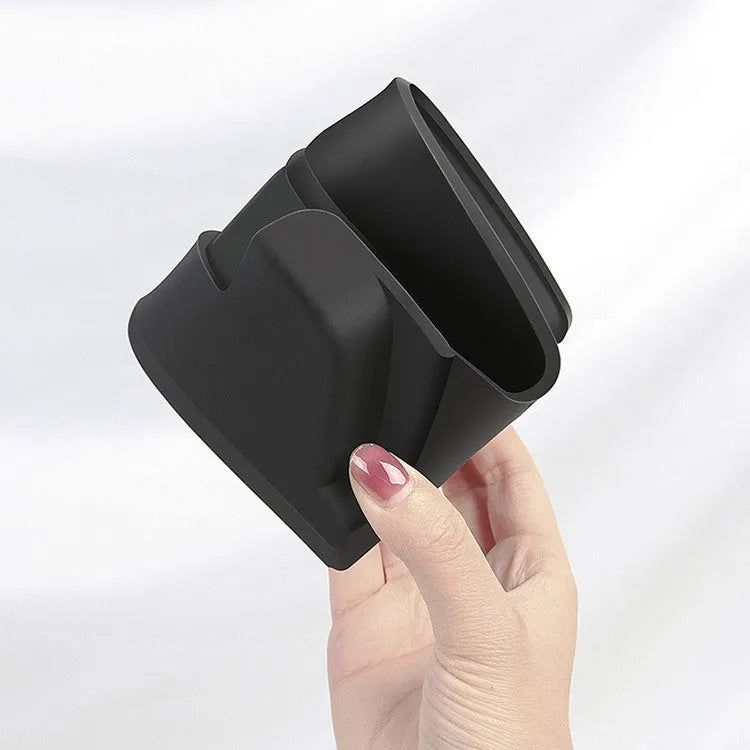 Black silicone sunglasses case mounted in Tesla centre console armrest compartment