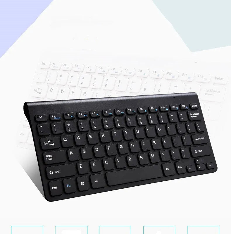 Black and white wireless keyboard and mouse set on a wooden desk