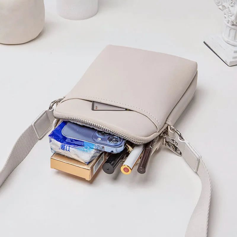 Black PU mobile phone bag with crossbody strap showing shoulder carry option