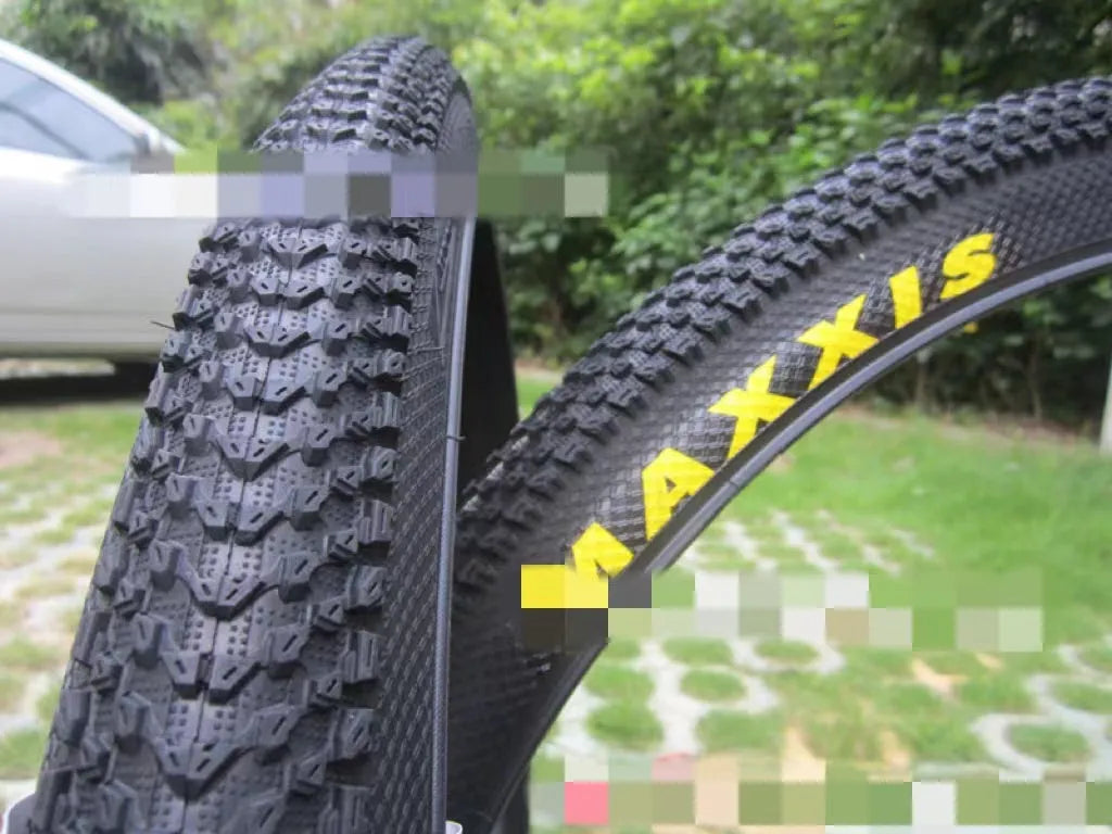 Ultralight mountain bike tyre with knobbly tread, shown in multiple size options including 26, 27.5 and 29 inch.
