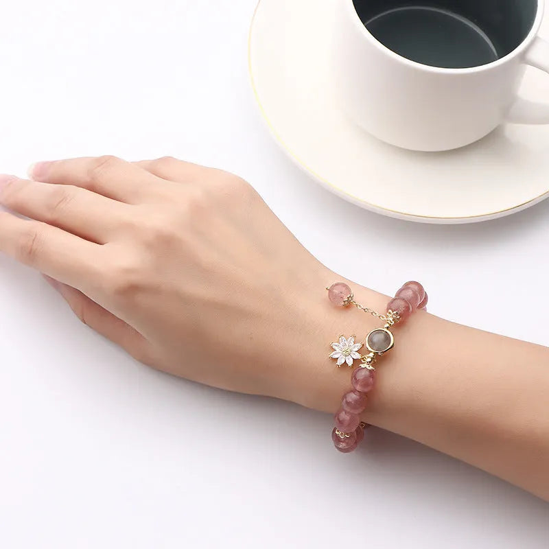 Strawberry quartz Mori style bracelet with electroplated floral details on a white background