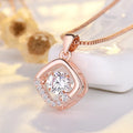 Close-up of a women's silver heart necklace pendant featuring a crown and bow design on a chain.