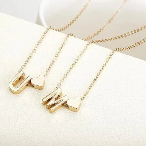 Peach-shaped alloy necklace pendant in a gold finish on a chain.