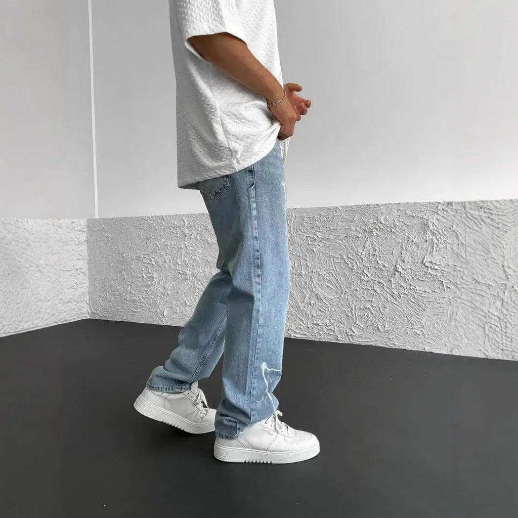 Blue men's straight-leg denim jeans with a loose wide-leg fit and mid-rise waist.