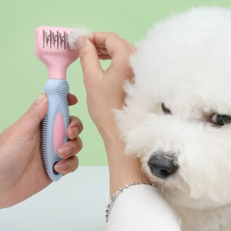Stainless steel dog comb and knot knife set with massage brush on a pink background