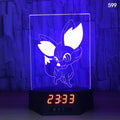 Glowing blue dolphin 3D LED night light on table with wireless charging spot